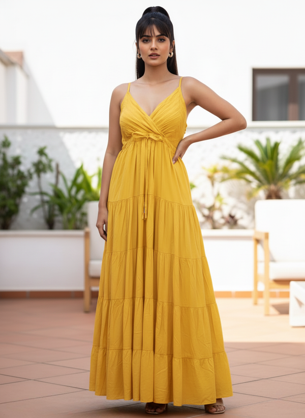 Woman in marigold yellow tiered maxi dress with criss-cross bodice, full front view