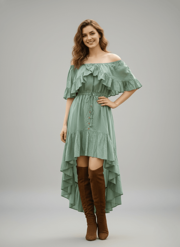 Model wearing a sage green off-shoulder dress with a high-low hem and knee-high boots
