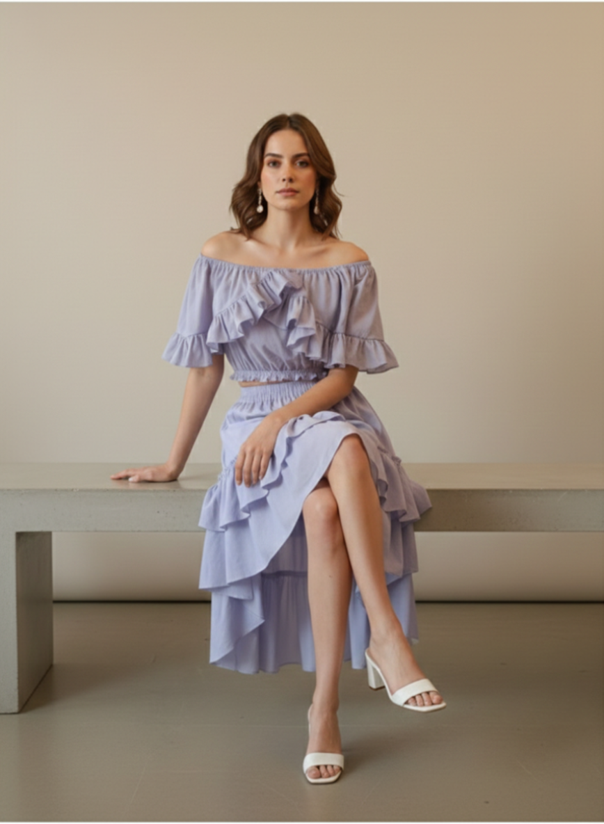 Woman sitting wearing lavender off-shoulder high-low cotton dress
