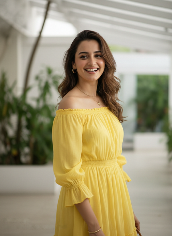 A close-up profile of a woman laughing while wearing a sunshine yellow off-shoulder dress, with soft natural light highlighting her and her wavy hair.